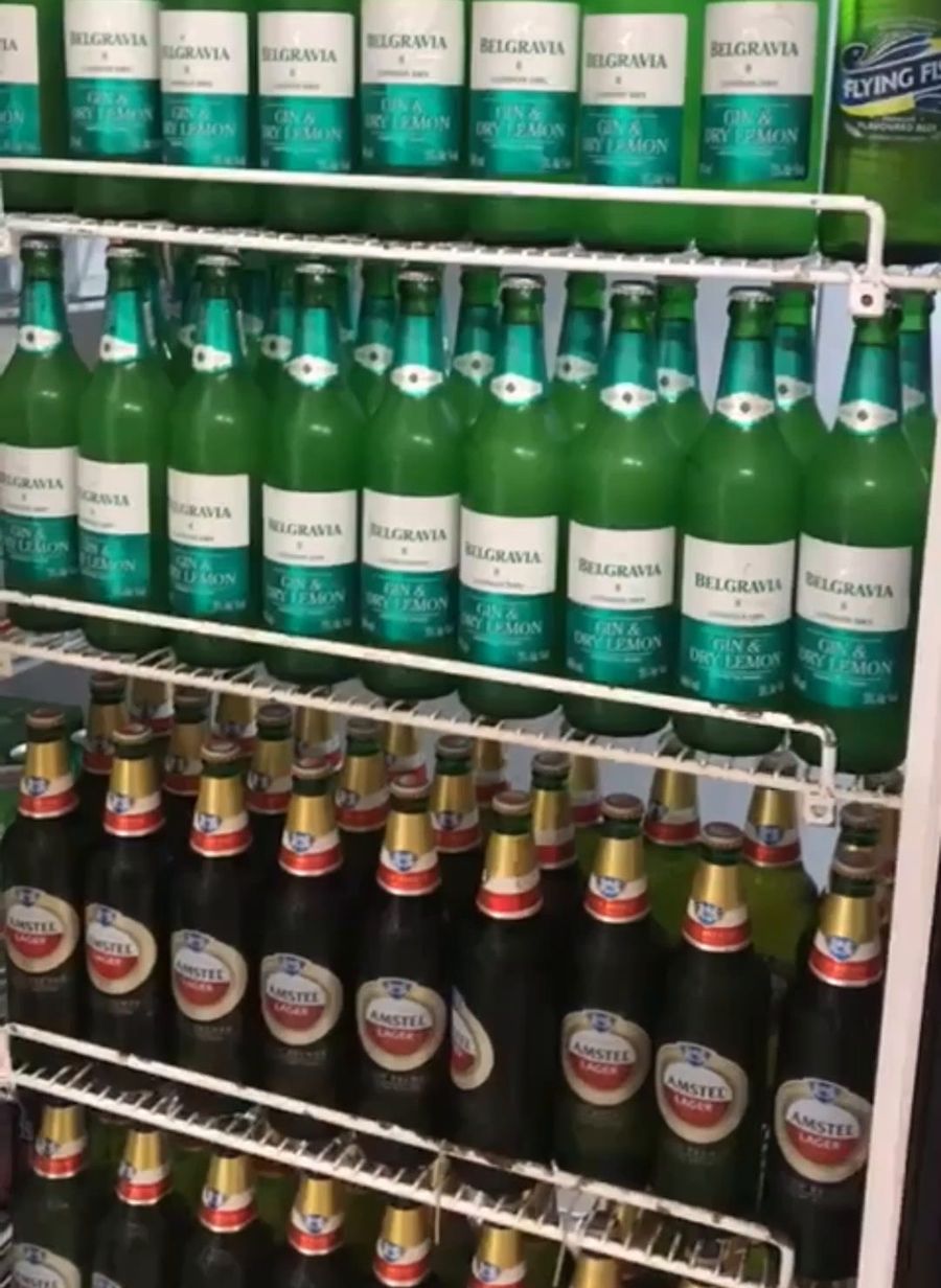 Wall of cider and beer bottles in the bottle store