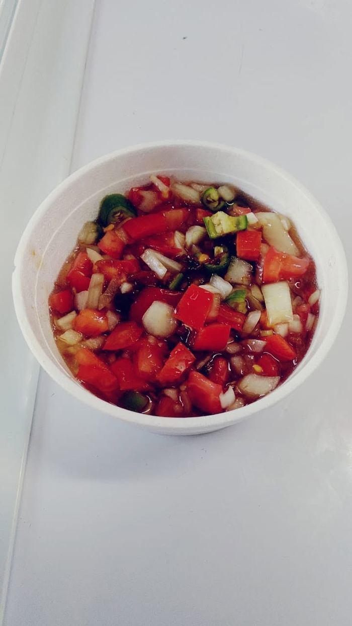 Tub of fresh tomato, onion and chilli salsa